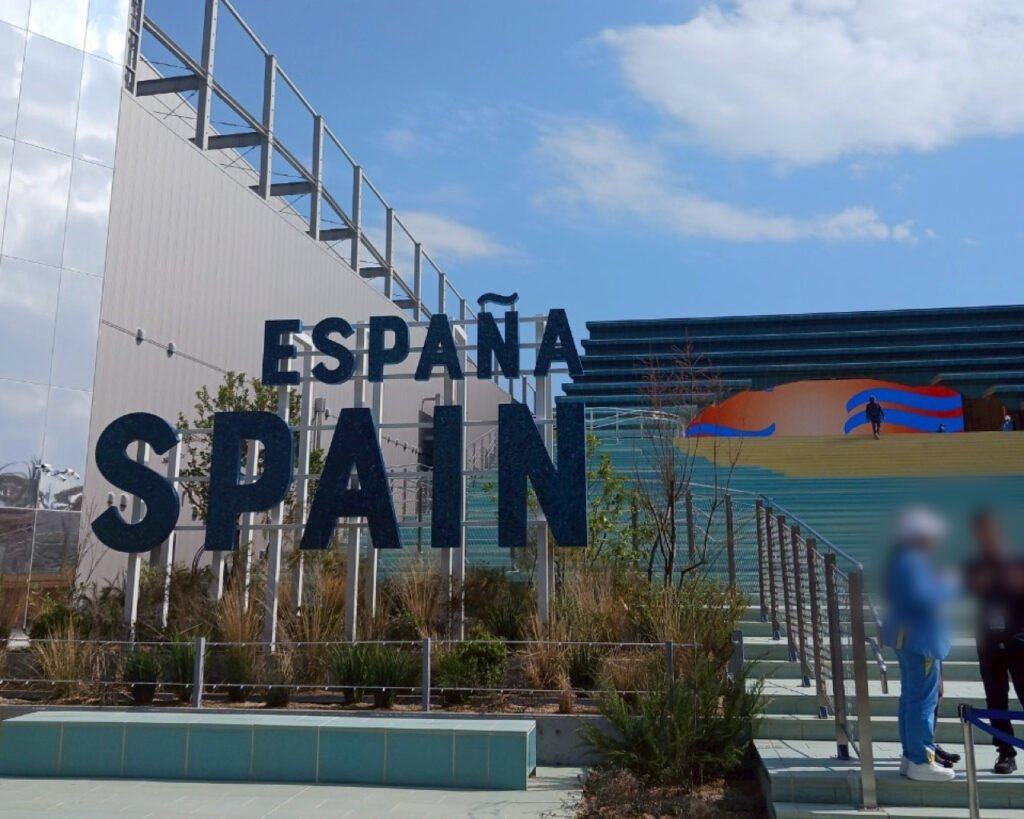 Exterior of the Spain Pavilion with large sign and colorful artistic steps